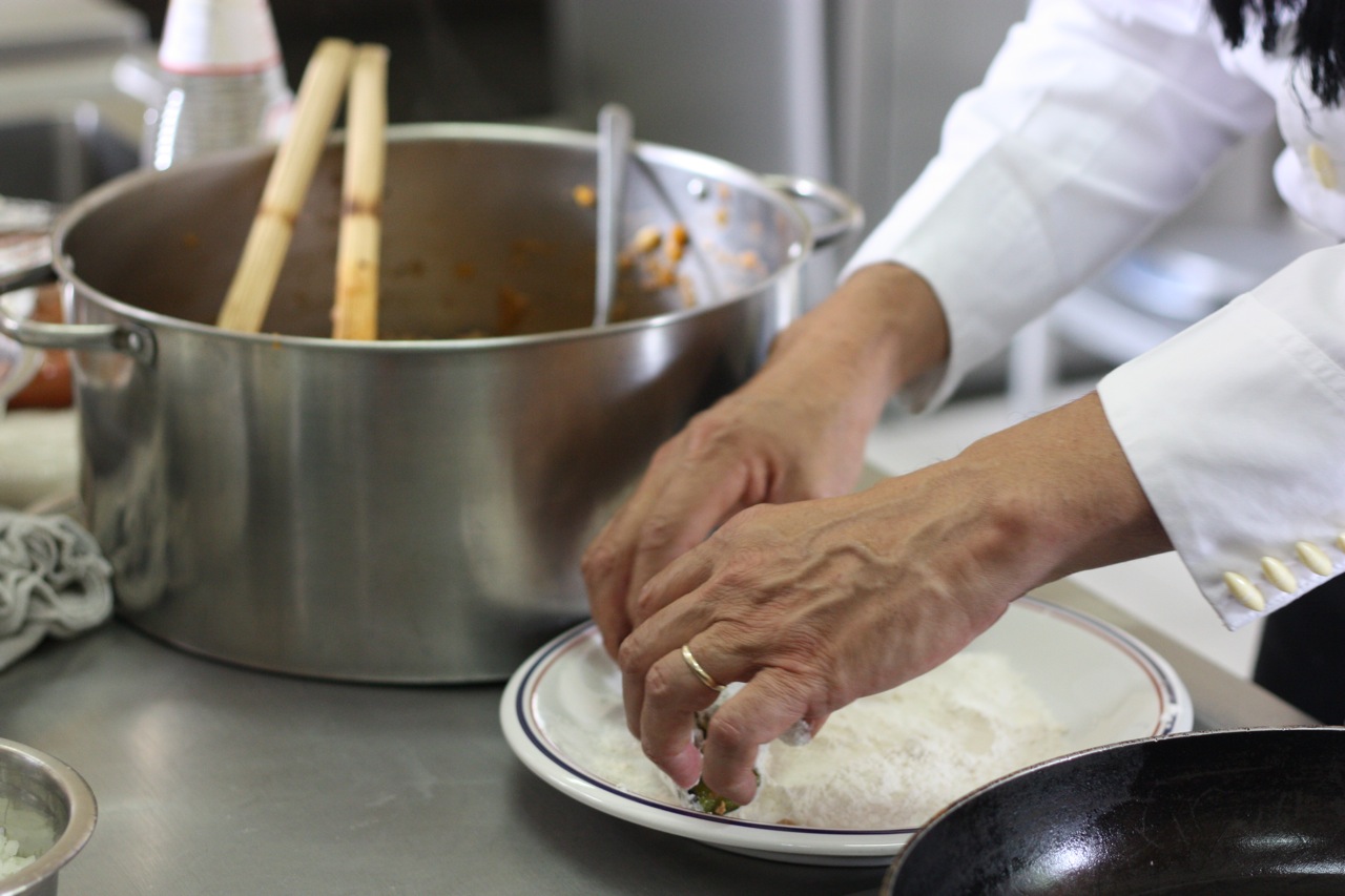 Dredging the chile in flour
