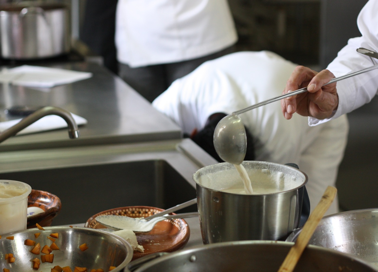 Pouring milk into the walnut sauce