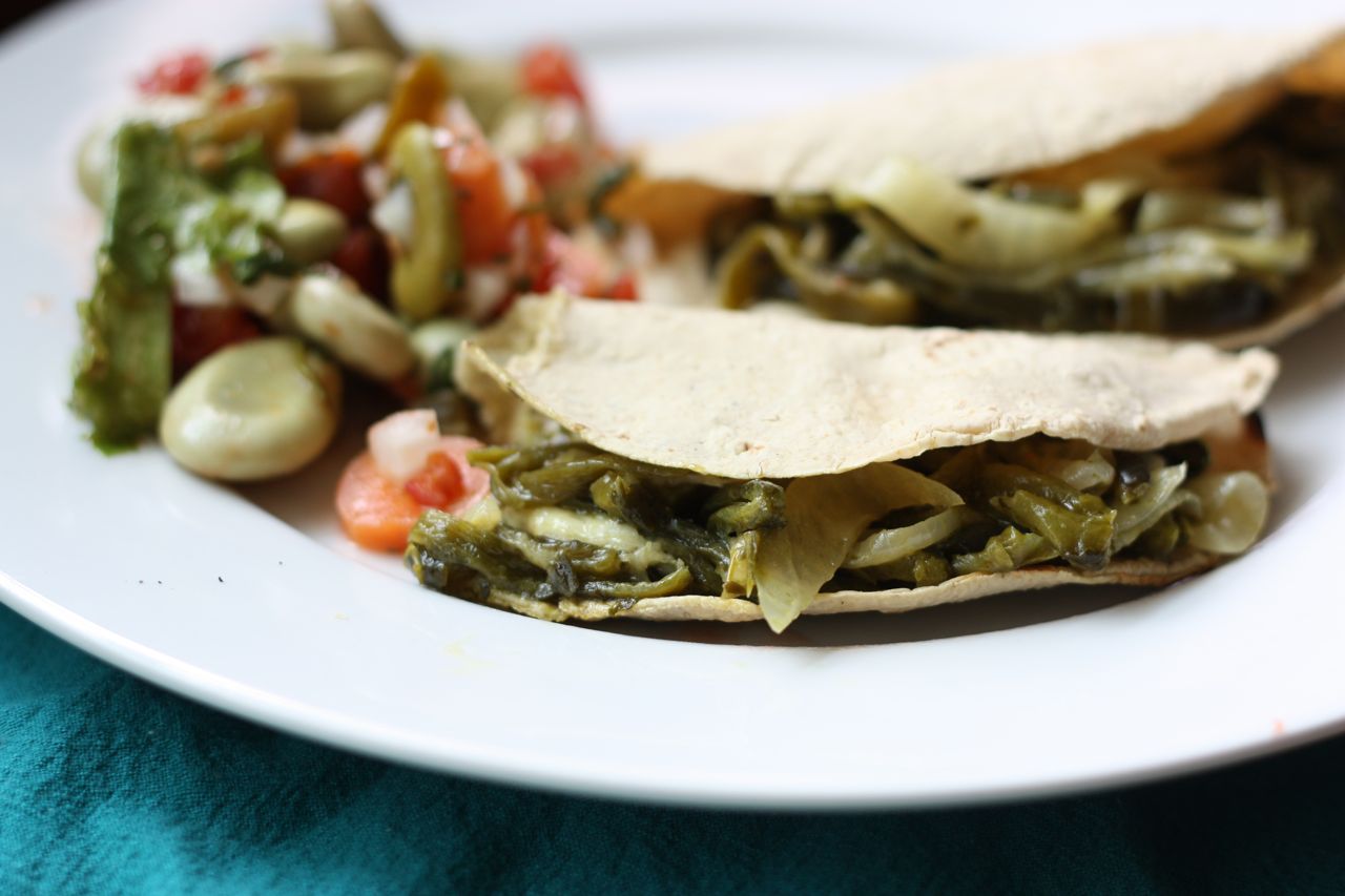 Tacos de rajas (roasted poblano pepper strips) with cotija cheese and fava bean salad